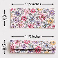 Two floral fabric strips measuring 1½ inches by ¾ inch, with one strip folded into thirds, illustrating how to prepare the shoulder straps for a doll pin doll dress.