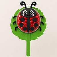 Ladybug fillable ornament half craft idea made with red and black candies for spring garden and children's decorations.