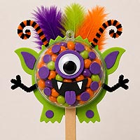 Candy monster fillable ornament half craft idea made with foam sheets, colorful candies, and feathers for kids' crafts and classroom projects.
