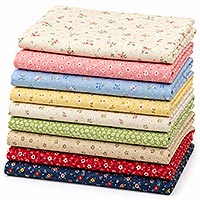 Stack of folded cotton craft fabrics in assorted floral and tiny-print patterns, featuring a mix of bright and soft colors for quilting, doll making, sewing, and other fabric crafts.